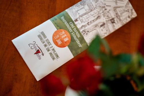 a ticket for a restaurant with a bowl of strawberries at Lilla Apartments in Odorheiu Secuiesc