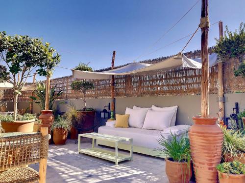a patio with a white couch and a table at Riad Dar Chacha in Marrakech