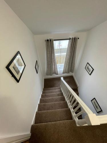 a staircase in a house with a window at 6 Church Street, Whitehaven - Perfect deployment location for Coast to Coast cyclists & hikers in Whitehaven