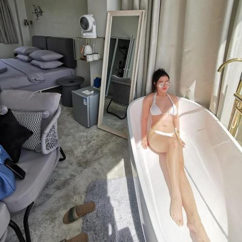 a woman in a bikini sitting in a bath tub at Sugarsea Inn & Dive shop in Mactan