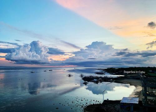 a view of a body of water at sunset at Sugarsea Inn & Dive shop in Mactan