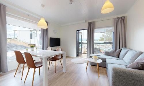a living room with a couch and a table at Hilmantori Apartments by Hiekka Booking in Kalajoki