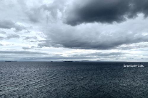 a large body of water under a cloudy sky at Sugarsea Inn & Dive shop in Mactan