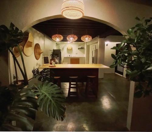 a kitchen with a large island in a room with plants at Inn Oon Villa in Chiang Mai
