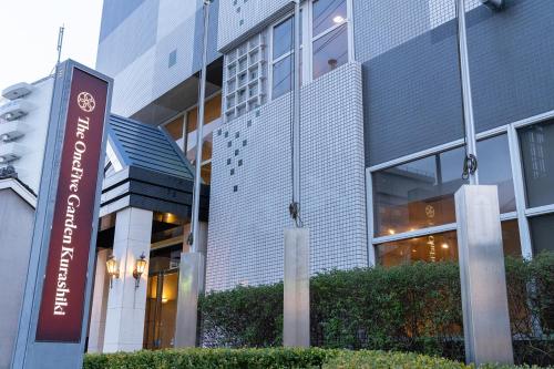 a building with a sign in front of it at The OneFive Garden Kurashiki in Kurashiki
