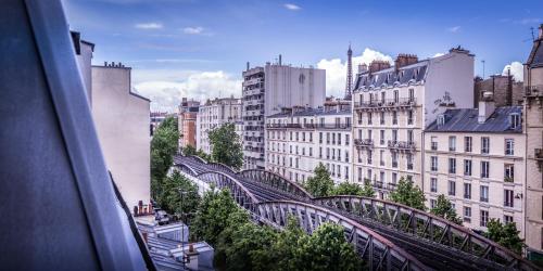 a view of a bridge in a city with buildings at Hotel Eiffel Segur in Paris