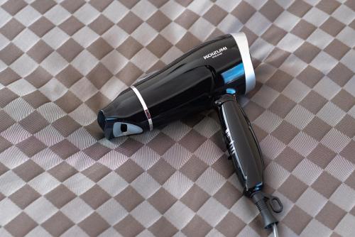 a hair dryer sitting on a checkered table at The OneFive Garden Kurashiki in Kurashiki