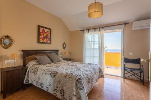 a bedroom with a bed and a sliding glass door at Beautiful duplex in Salobreña in Salobreña