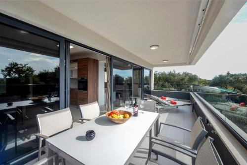 an open balcony with a table and chairs at Villa Marija in Sveti Filip i Jakov