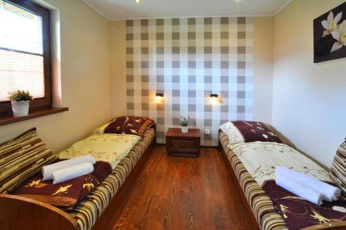a room with two beds and a window at Holiday homes near the lake, mini zoo in Gleźnowko