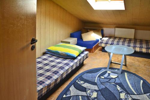 a small room with two beds and a table at Villa in Swiecianowo near Baltic Sea in Paproty