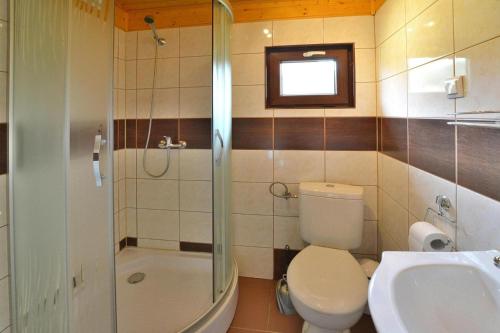 a bathroom with a toilet and a shower and a sink at holiday home, Rusinowo in Rusinowo