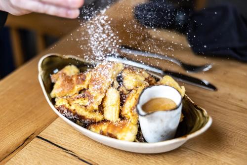 a bowl of food with powdered sugar on a table at Hotel Schützenhof in Flachau