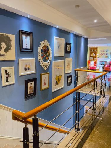 a blue wall with pictures on it with a staircase at Homie B&B in Hualien City
