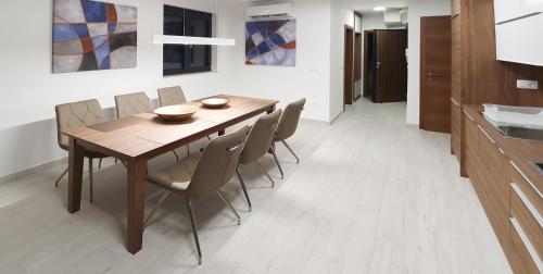 a dining room with a wooden table and chairs at Villa Marija in Sveti Filip i Jakov
