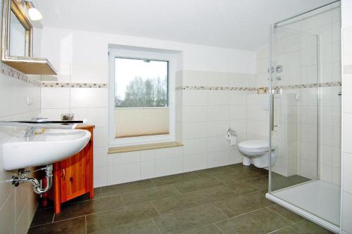 a bathroom with a toilet and a sink and a shower at Apartment, Ribnitz-Damgarten in Ribnitz-Damgarten