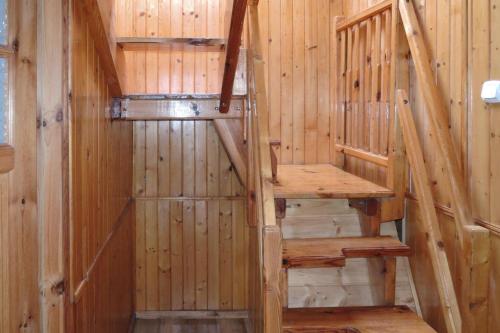 a wooden sauna with stairs in a cabin at Semi-detached house, Wiselka in Wisełka