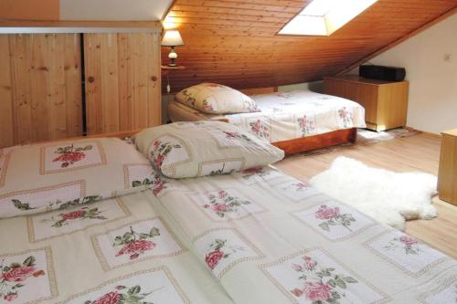 two twin beds in a room with wooden ceilings at Semi-detached house, Wiselka in Wisełka