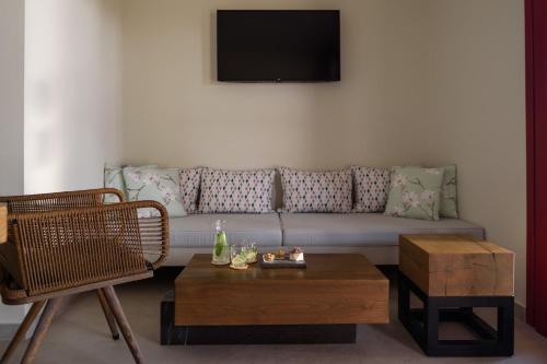 a living room with a couch and a coffee table at Potnia Theron Suites in Akrotiri