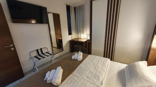 a bedroom with a bed with white shoes on it at Villa Ivan in Sveti Filip i Jakov