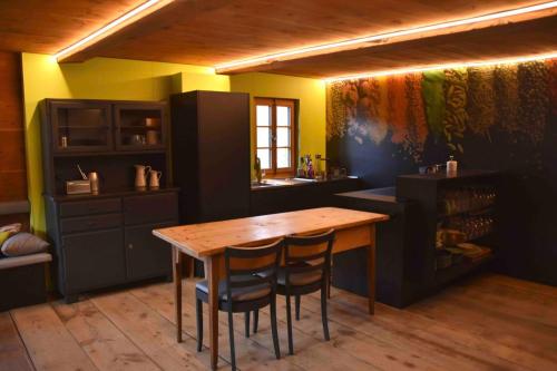 a kitchen with a wooden table and two chairs at Appartement for Holiday Lodge 1891 in Stalden