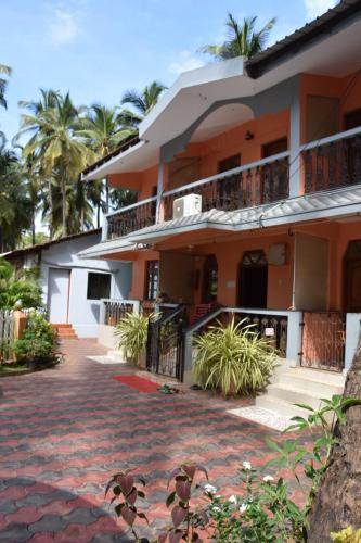 a house with a brick walkway in front of it at Hilias Retreat in Palolem