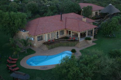 an overhead view of a house with a swimming pool at Boubou Bed and Breakfast in Rustenburg