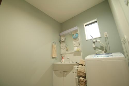 a bathroom with a toilet and a sink and a window at Kumamoto - House - Vacation STAY 89433 in Kumamoto