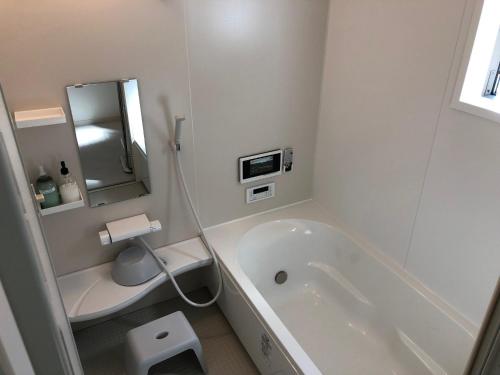 a white bathroom with a tub and a sink at Kumamoto - House / Vacation STAY 75194 in Kumamoto