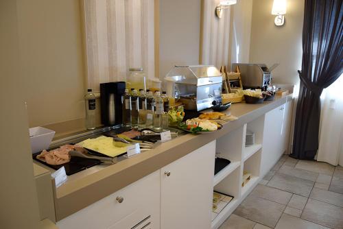 a kitchen with a counter with food on it at Hotel Parco delle Querce in Crispiano