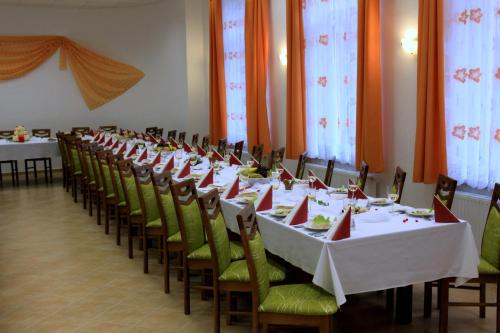a row of tables and chairs in a room at Hotel Rabbit in Trhový Štěpánov