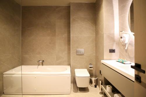 a bathroom with a toilet and a sink at The Central View Boutique Hotel in Vlorë
