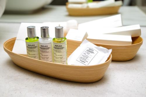 a wooden tray with three bottles of essential oils at Hotel Muso in Kyoto