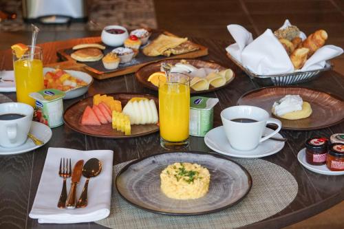 a table topped with plates of breakfast foods and drinks at Crowne Plaza Porto by IHG in Porto