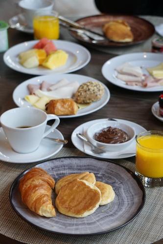 a table topped with plates of breakfast foods and coffee at Crowne Plaza Porto by IHG in Porto