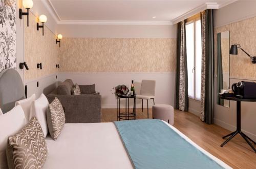 En eller flere senge i et værelse på Grand Hôtel Lévêque