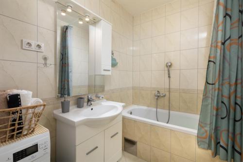 a bathroom with a sink and a bath tub at Sea View Apartment Michelle near Osejava in Makarska