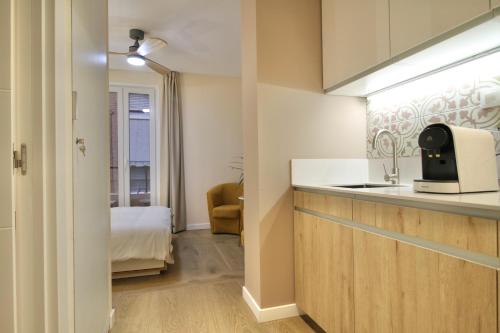 a small kitchen with a sink and a microwave at A Loft You Will Fall In Love With in Tarragona