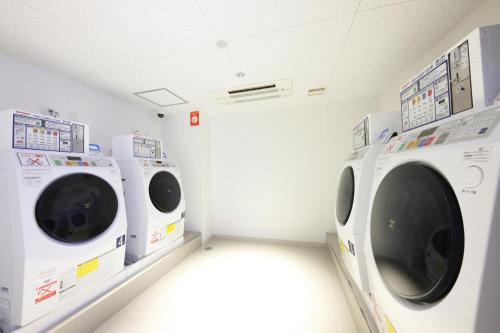 a laundry room with two washing machines in it at Daiwa Roynet Hotel Morioka Ekimae in Morioka