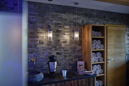 a kitchen with a brick wall with chandeliers at Residence Panorama Pfelders in Pfelders