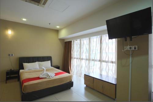 a bedroom with a bed and a large window at T Hotel Jalan Tar in Kuala Lumpur