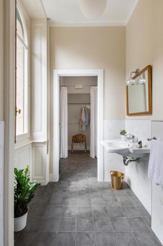 a bathroom with a sink and a white tub at Villa Maria Boutique Apartments in Cannobio