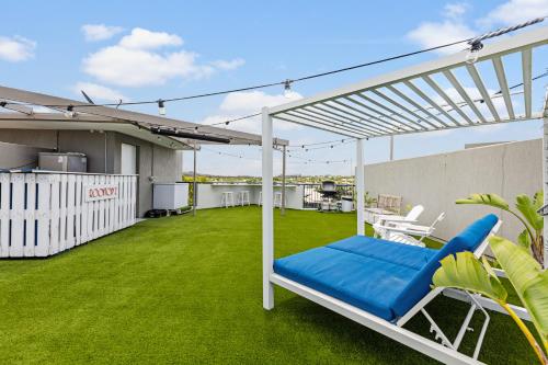 a white pergola on a balcony with a lawn at The Penthouse Mooloolaba, Private Luxury Rooftop Living in Mooloolaba