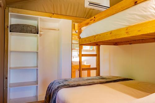 a bedroom with a bunk bed and a bunk bed at AfriCamps Hoedspruit in Hoedspruit