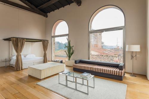 a living room with a couch and two windows at Riva Lofts Florence in Florence