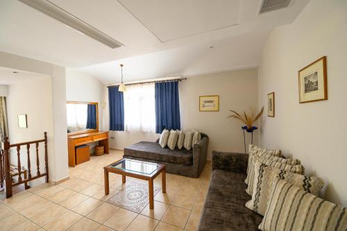 a living room with a couch and a table at Hotel Europa Olympia in Olympia
