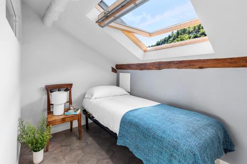 a bedroom with a bed and a skylight at Villa Maria Boutique Hotel in Cannobio
