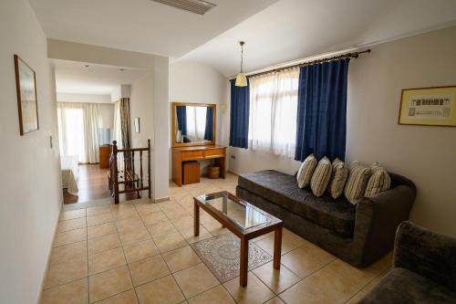 a living room with a couch and a table at Hotel Europa Olympia in Olympia