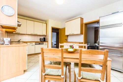 a kitchen with a wooden table and chairs at Apartments Overath in Overath