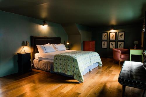 a bedroom with a bed and a chair at Star & Garter in Falmouth